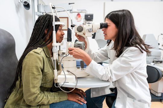 Optician Conducting Eye Examination with Patient