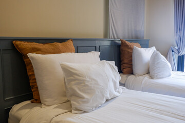 Hotel room scene with bed pillows and lamp on table,White soft pillows on bed,contemporary,Space for text.