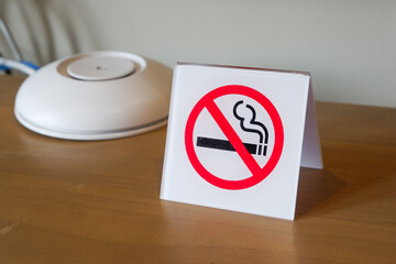 White no smoking sign displayed on table in hotel,Hotel room scene,contemporary,Space for text.