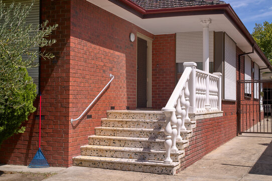 Sturdy brick steps lead to a 'Italianized' Melbourne brick home