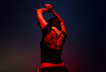 Dancer performing under dramatic lighting during a nighttime eve