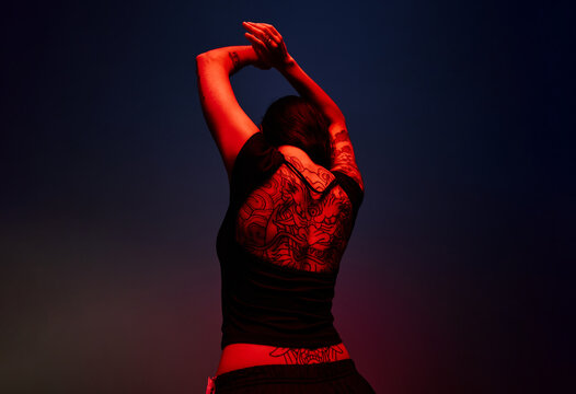 Dancer performing under dramatic lighting during a nighttime eve