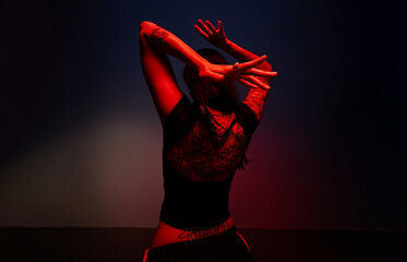 Contemporary dancer showcases expressive movement in studio ligh