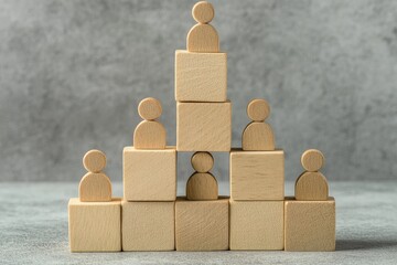 Wooden blocks arranged in a pyramid shape, with small wooden figures on top of each block.  A hierarchical structure is implied