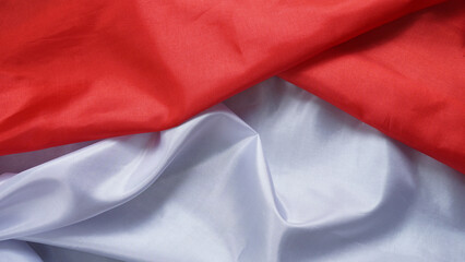 Crumpled red and white Indonesian flag fabric texture isolated as background