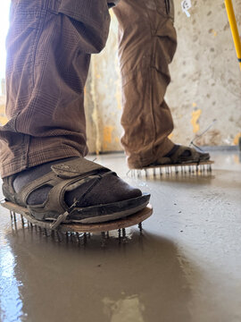 Spiked shoes for walking on fresh self-leveling floor
