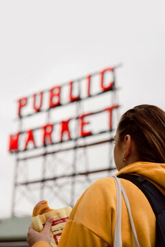 Woman Holding Pastry at Pike Place Market

