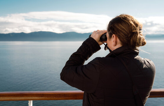 Woman Using Binoculars on Cruise Ship Deck