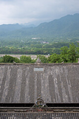 Historic architecture overlooks lush mountains in DuJiangYan, Si