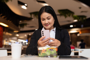 woman in restaurant using smartphone