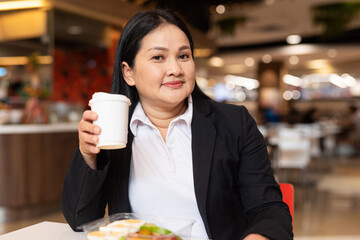 Portrait of a woman in cafe holding coffee cup