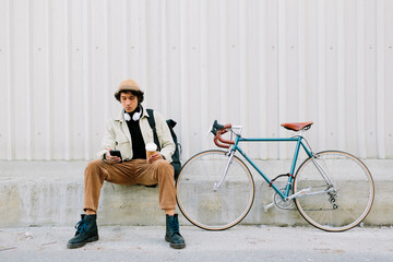 Man sitting with bicycle
