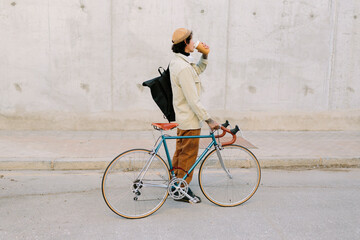 Man drinks coffee with bicycle