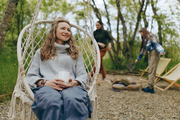 Middle age woman enjoying a healthy and active lifestyle outdoors with a warm sweater and relaxed...