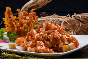 The uniquely shaped Kung Pao shrimp balls are placed on a black background