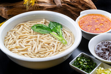 Fish with tomato sauce on black background