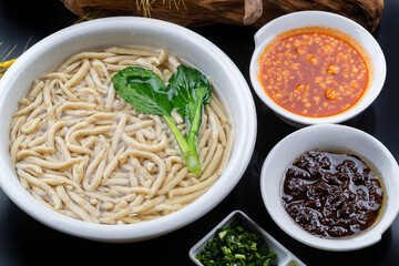 Fish with tomato sauce on black background