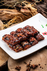 Fried eggplant with minced meat sauce on a camphorwood chopping board