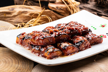 Fried eggplant with minced meat sauce on a camphorwood chopping board