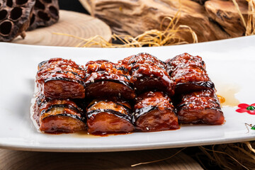 Fried eggplant with minced meat sauce on a camphorwood chopping board