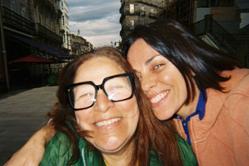 Tourist Friends Smiling for City Selfie
