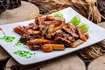 Rectangular porcelain plate with scallion-roasted ginseng on a camphorwood chopping board