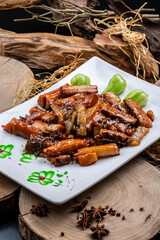 Rectangular porcelain plate with scallion-roasted ginseng on a camphorwood chopping board