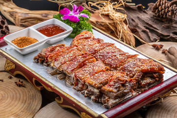 Mongolian grilled lamb chops in a red lacquer plate on a camphorwood chopping board
