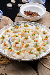 Sizzling prawns on a camphorwood chopping board