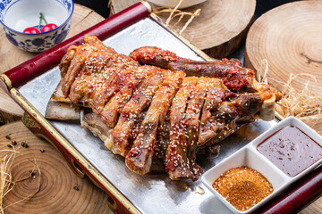 Roasted lamb legs from the grasslands outside the Great Wall are placed on a camphorwood chopping...