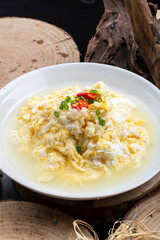Spring water scrambled eggs in a white porcelain plate