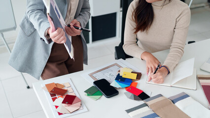 Asian Interior Designers Teamwork on Color and Fabric Selection for Modern Home Renovation Project Planning, Meeting, and Creative Design at Workplace Office