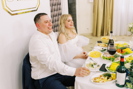 Bride and Groom Celebrating at a Wedding Reception Dinner Table