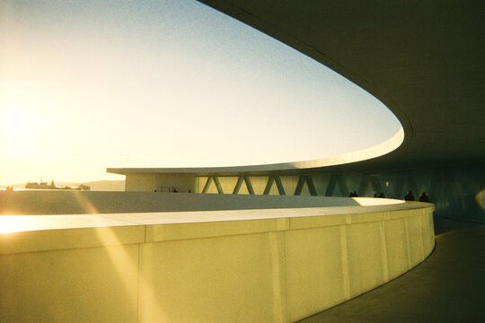 Modern architecture at sunset with human shadows on the wall

