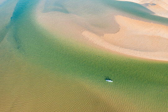 Kayak on turquoise water of a shallow tidal estuary 