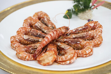 Braised Thai black tiger shrimp in white porcelain plate