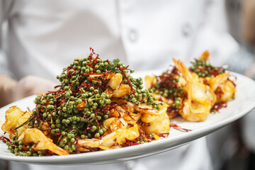 The chef shows the Sichuan-style pepper prawns just out of the pot
