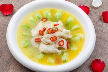 Longli fish in sour soup in a white round porcelain plate