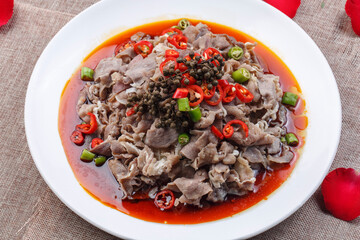 White round porcelain plate with boiled beef in hot pepper sauce