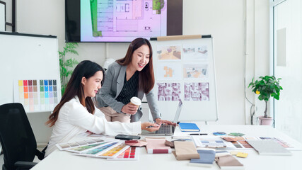Asian Interior Designers Teamwork on Laptop for Home Renovation Project Consultation Meeting in...