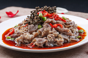 White round porcelain plate with boiled beef in hot pepper sauce