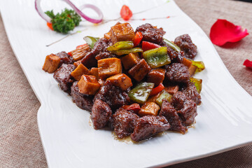 White long porcelain plate with king oyster mushroom cubes