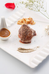 Sizzling New Zealand fillet steak on a white porcelain plate