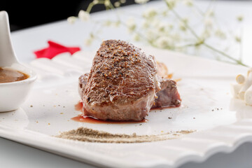 Sizzling New Zealand fillet steak on a white porcelain plate