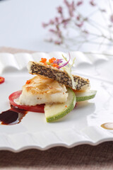 French-style pan-fried cod on a white porcelain plate