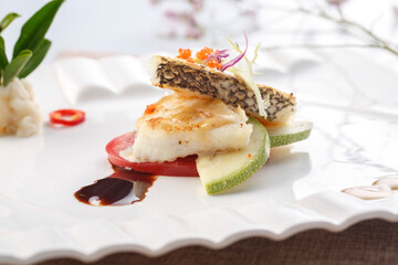 French-style pan-fried cod on a white porcelain plate