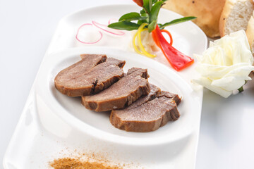 Braised beef tongue in sizzling sauce on a white porcelain plate