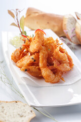 French style sizzling salt and pepper shrimp on a white porcelain plate