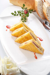 Homemade breakfast sandwich on a white porcelain plate