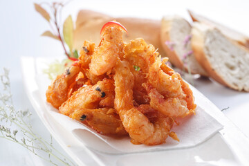French style sizzling salt and pepper shrimp on a white porcelain plate